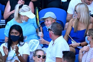 A child smles after Nick Kyrgios gave him his racquet after being hit by a tennis ball