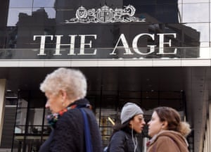 People walk past the offices of the Age in Melbourne