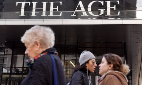 People walk past the offices of the Age newspaper in Melbourne 