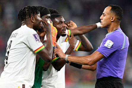 Ghana players appeal to referee Ismail Elfath (right) after he awarded a penalty after Ghana’s Mohammed Salisu fouled Portugal’s Cristiano Ronaldo in the penalty box.