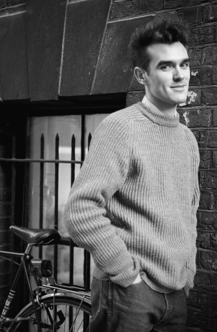 Oversized knits and quiff: Morrissey, with his bicycle.