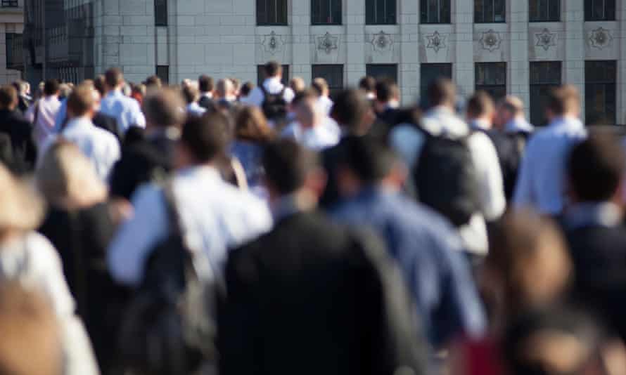 Pedestrian commuters walking across London Bridge
