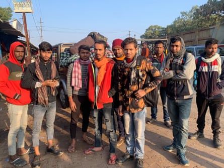 A group of Indian men standing on a street