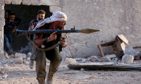 Members of the Jaish al-Fatah coalition clash with Assad regime soldiers in Ramouseh on Saturday.