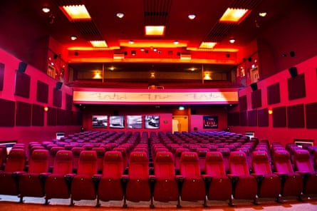 The interior of the Plaza cinema featuring rows of red velvet seats
