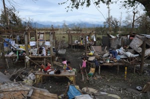 Children play amongst their destroyed houses after typhoon Haima struck the province of Isabela