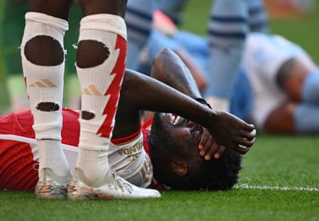 Arsenal's Thomas Partey reacts after clashing heads with Kyle Walker.