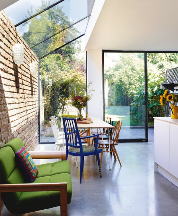 A bright, glass-roofed extension has replaced a gloomy side alley; the architects designed and made the tabletop with metalworkers geblondon.com; the blue chair is by Yinka Ilori and the Danish sofa from sunburyantiques.com.