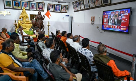 People watch the election results live on a television at the Bharatiya Janata Party (BJP) office in Chennai on 4 June 2024.