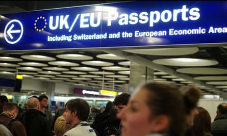 Passengers wait to pass through immigration checks at London Heathrow airport.