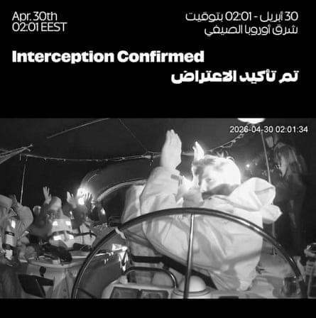 CCTV footage posted online shows members of the IDF boarding flotilla vessels sailing to Gaza, black and white shot of people wearing lifejackets with arms raised in position of surrender