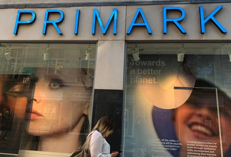 A woman walks past a window display at a Primark store in Liverpool, Britain.