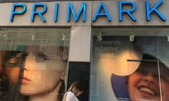 A woman walks past a window display at a Primark store in Liverpool