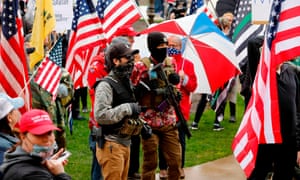 In April, protesters wearing the Trump insignia and semi-automatic rifles stormed the state capital in Lansing, Michigan.