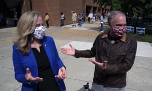 Senator Tim Kaine (R) jokes with congresswoman Abigail Spanberger (both represent Virginia) after she arrived at a voting station to vote early in the 2020 election.
