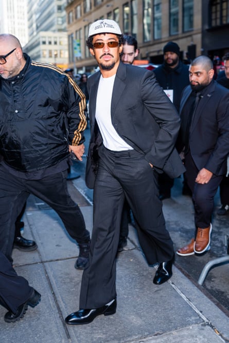 a man in a dark suit with a white T-shirt