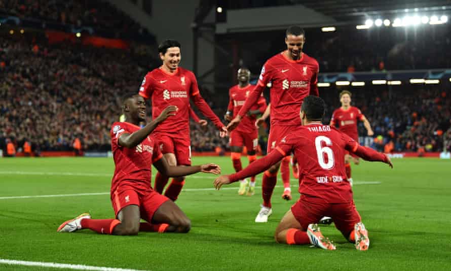 The Liverpool players rush to Thiago Alcântara after he broke the deadlock with a rasping drive.