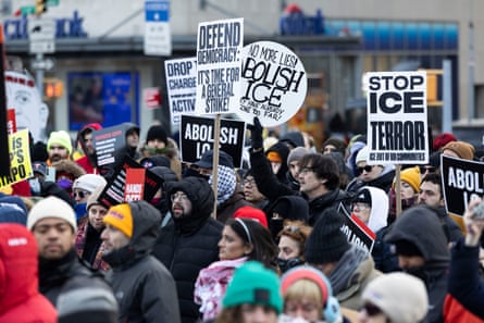 Protesters hold signs as people gather for an emergency protest after Federal Agents shot and killed a Minneapolis resident and I.C.U nurse named Alex Jeffrey Pretti