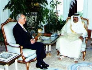 Peres with a man in Arab dress, both sitting on gilt chairs