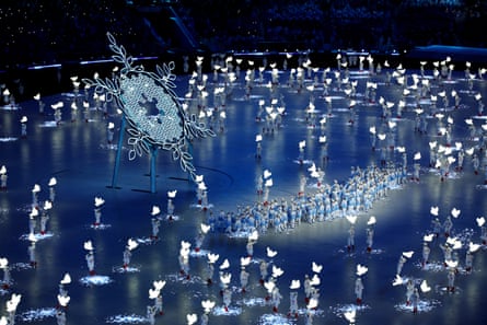 Dancers perform around the large snowflake during the opening ceremony