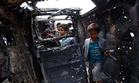 Yemeni children inspect a charred vehicle after two improvised explosive devices went off in the capital, Sana’a.