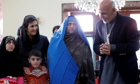 Afghanistan’s president Ashraf Ghani speaks to Sharbat Gula, in blue, in Kabul on Wednesday.