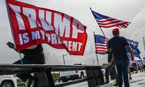 people wave US flags and flag that says 'trump is my president'