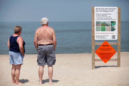 Signs on the Lake Erie beach warn about the algae in August 2014.