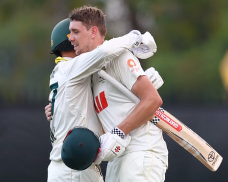 Green gets a hug from Nathan Lyon after reaching his milestone.