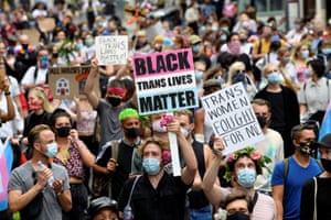 People hold placards reading Black Trans Lives Matter