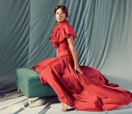McCall in silky full-length red dress with ruffles across top