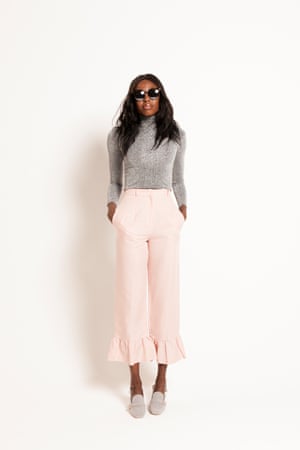 grey sparkly roll neck top, pale pink cropped trousers with ruffles on bottom, pale grey shoes with gold buckle detail