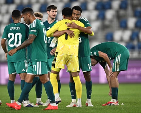 Shea Charles (centre, facing the camera) embraces his younger brother, the goalkeeper Pierce Charles, after Northern Ireland's dramatic win in Georgia.
