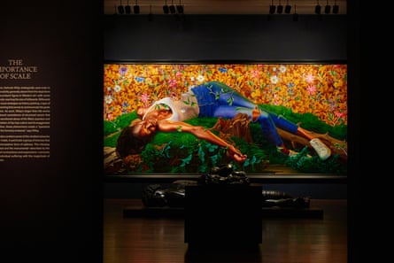 painting of figure lying down seen in darkened gallery