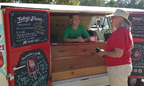 Will Lemke of Six Strawberries serves free popsicles to an unidentified teacher at Ballard high school. The local community has been largely supportive of the teacher strike.