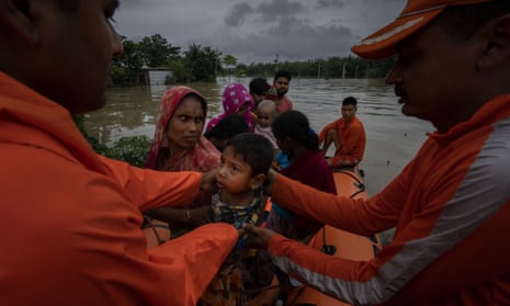 Indian disaster response workers rescue flood-hit villagers west of Gauhati, India