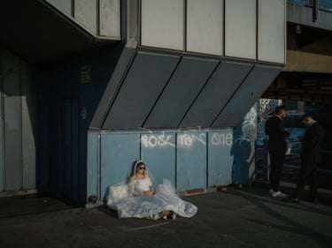 A bride watches the sunset under the Galata Bridge in Eminönü, Istanbul, Turkey, 2025