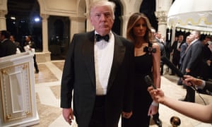 Melania Trump, right, looks on as her husband President-elect Donald Trump talks to reporters during a New Year’s Eve party at Mar-a-Lago. (AP Photo/Evan Vucci)