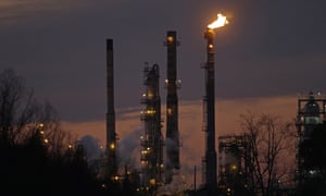Stacks and burn-off from the Exxon Mobil refinery, at dusk in St Bernard Parish, Louisiana.