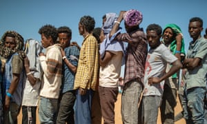 Refugees are queuing up for food distribution at the Um Raquba settlement.