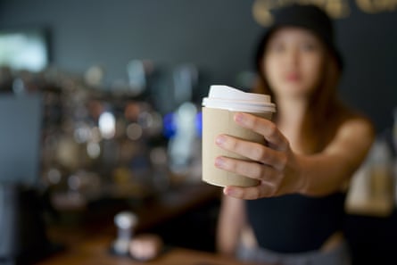 A barista serves a coffee in a shop
