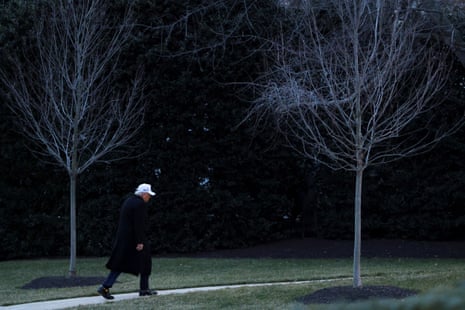 Donald Trump walks across the South Lawn.