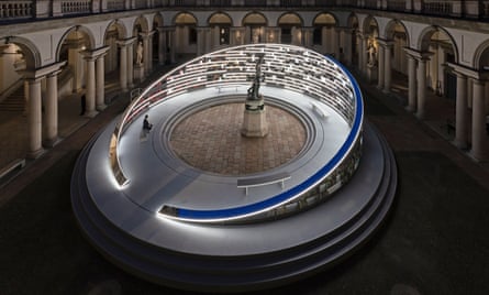 A curved, lit library in a courtyard