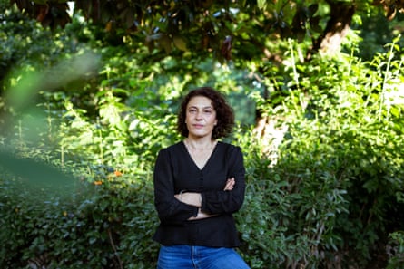 Gülsüm Kav, a doctor and women’s rights campaigner in Turkey, with bushes behind her