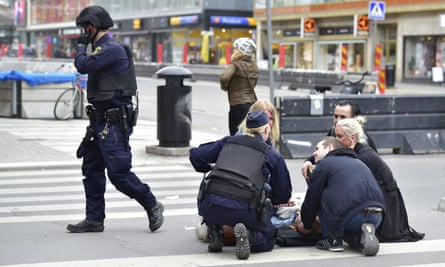 Police assist people on the streets of Stockholm.