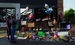 People take photos of a memorial to Rayshard Brooks at the Wendy’s where he was shot and killed by police officers, in Atlanta, Georgia,