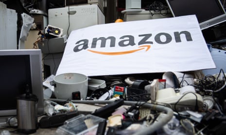 A placard with Amazon’s logo atop lots of trashed appliances