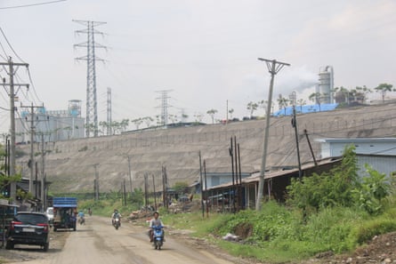 A road next to a large concrete embankment