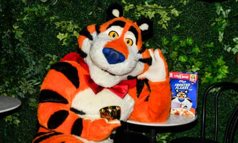 Tony the Tiger sits with a box of frosted flakes