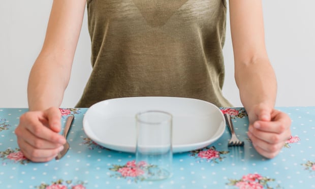 woman in front of an empty plate. 